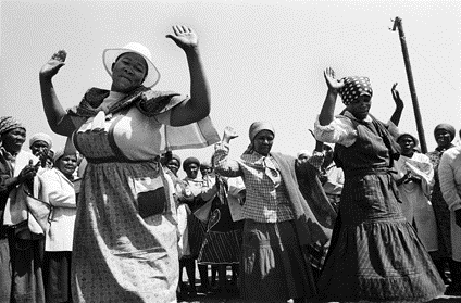 Braklaagte women break into a spontaneous dance after signing a petition against incorporation into the Bophuthatswana 'homeland'  Black and white photographs