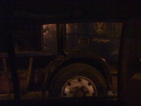 Driving through Tahrir Square. There are flood lights and riot vans. Police sit waiting.