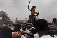A traditional dancer and crowd salute Jean-Pierre Bemba as he makes his way to a rally from the airport, Kinshasa