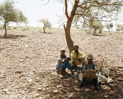 Three men rest at the side of the track between Bute Asbestos Mine and Heuningvlei in Northern Cape. 18 December 2002